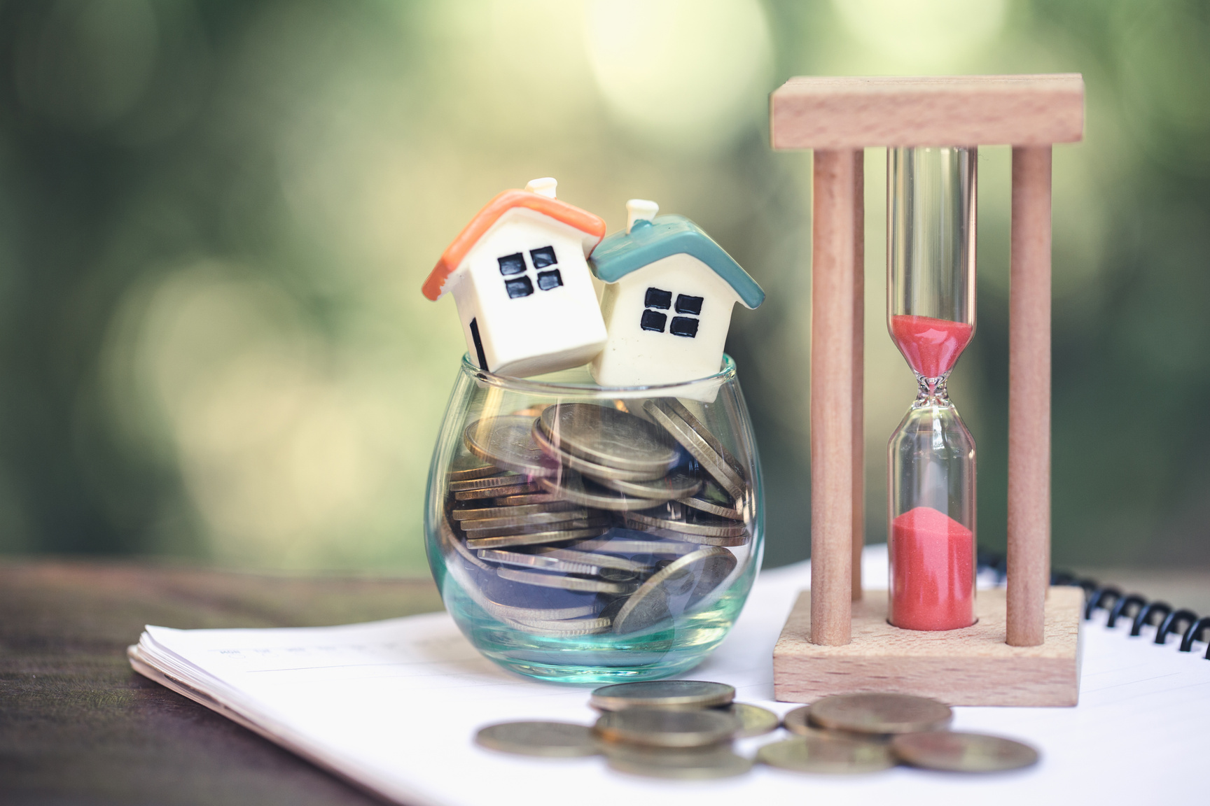 House model and coin,  Concept of property management, home, Invesment and Risk Management.